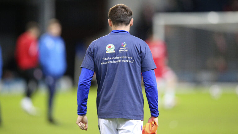 Blackburn Rovers defender Harry Pickering (3)warming up in the Benefit Mankind T-Shirt during the EFL Sky Bet Championship match between Blackburn Rovers and Middlesbrough at Ewood Park, Blackburn, England on 29 December 2022.