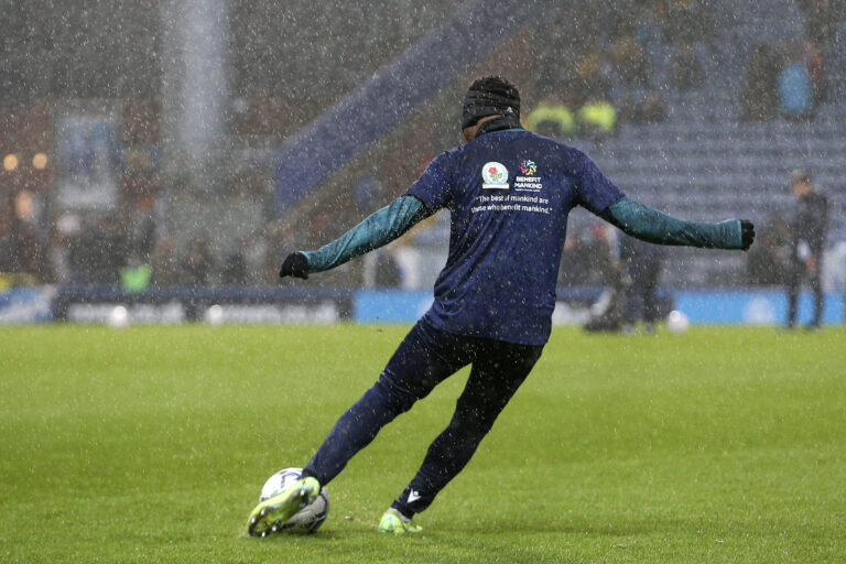 Blackburn Rovers midfielder Tayo Edun (20) warming up in the rain during the EFL Sky Bet Championship match between Blackburn Rovers and Preston North End at Ewood Park, Blackburn, England on 4 December 2021.